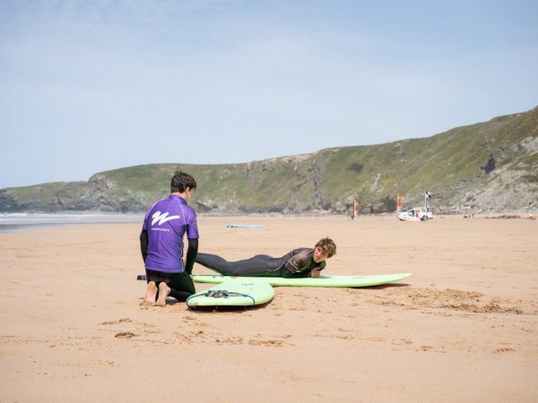 Wavehunters Watergate Bay surf school instructor with students